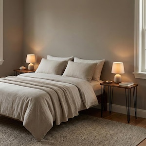 May include: Walnut nightstand with solid wood top and black hairpin metal legs, styled beside a bed with lamps in a cozy modern bedroom.
