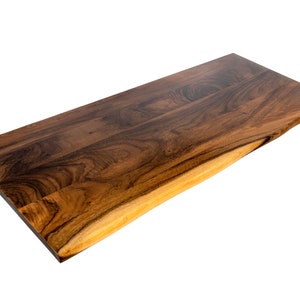 Standing desk wood top made from solid walnut with a natural live edge and an eco-friendly finish, combining durability with eco-conscious craftsmanship.