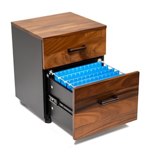 May include: A two-drawer filing cabinet with a walnut finish. The top drawer is closed, and the bottom drawer is open, revealing blue file folders.