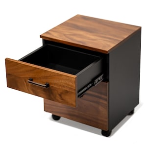 May include: A solid wood file cabinet with two drawers, one open, on black wheels. The storage cabinet has a dark walnut finish and black metal accents.