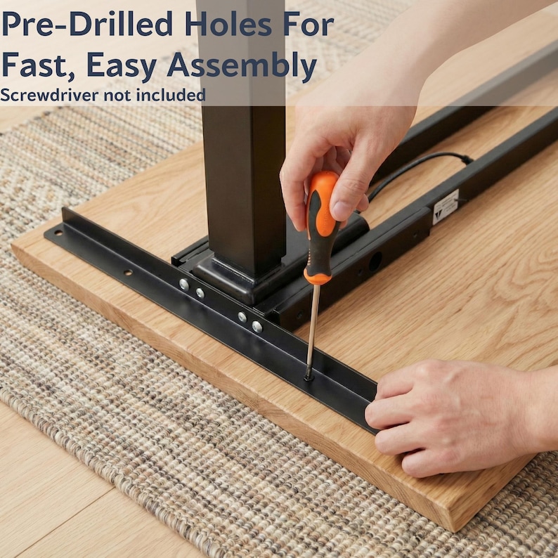 May include: A close-up view of a desk assembly. The image shows a person using an orange and black screwdriver to attach a metal bracket to a wooden tabletop. The text in the image reads: "Pre-Drilled Holes For Fast, Easy Assembly. Screwdriver not included."