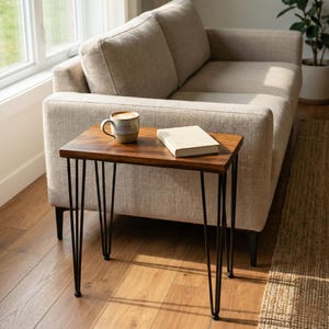 May include: Walnut end table with solid wood top, black hairpin metal legs, and modern living room styling beside a beige sofa.