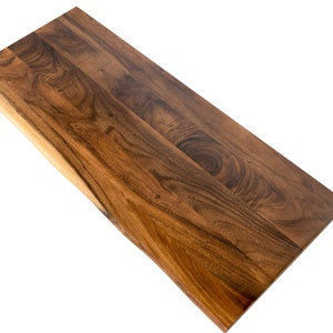 Solid walnut wood desk top featuring a natural live edge and an eco-friendly finish, ideal for crafting custom wood table tops.