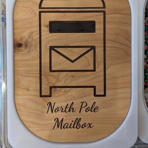 May include: A wooden mailbox with a cutout of a mailbox and the text "North Pole Mailbox".