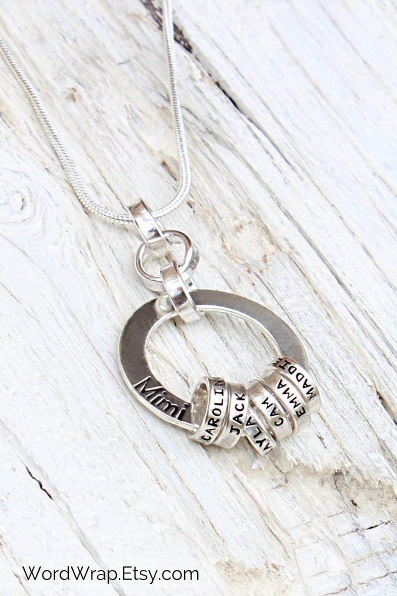 Sterling silver necklace for Grandmother with tiny rings stamped with grandkids names, around a washer.