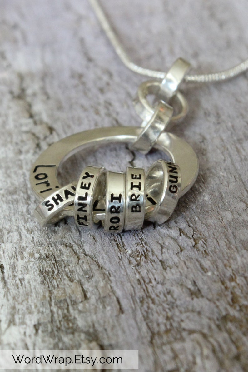 Sterling silver necklace for Grandmother with tiny rings stamped with grandkids names, around a washer.