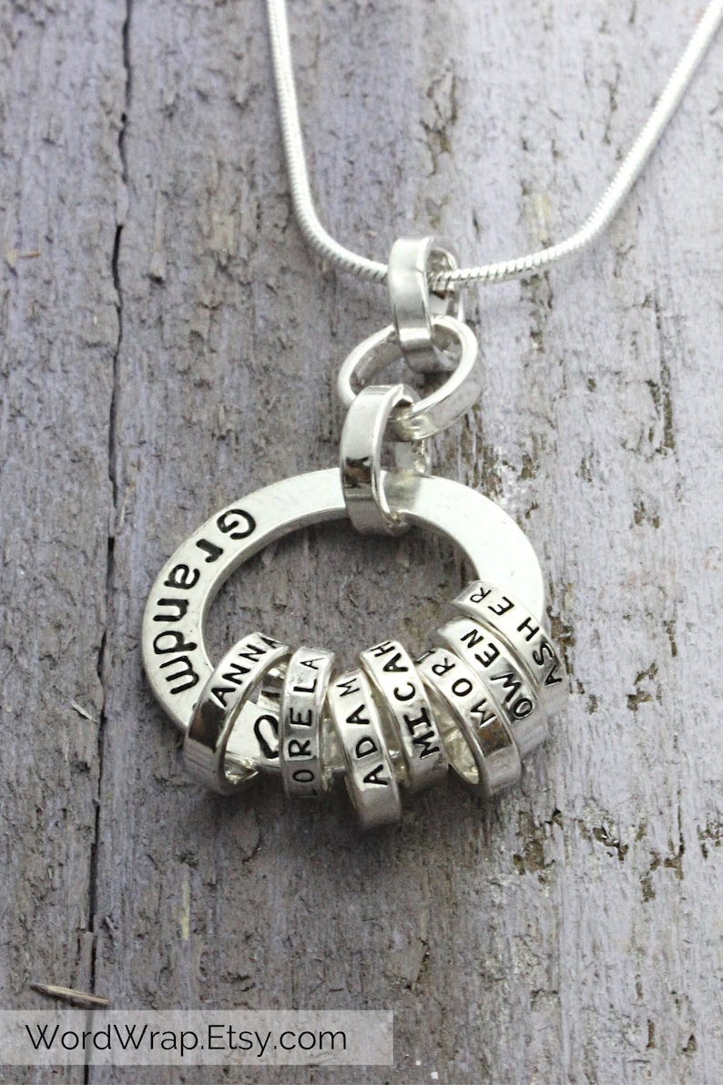 Sterling silver necklace for Grandmother with tiny rings stamped with grandkids names, around a washer.