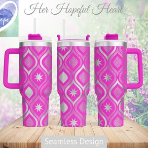May include: A pink stainless steel tumbler with a silver geometric pattern and a handle. The tumbler has a lid with a straw. The text "Her Hopeful Heart" is at the top of the image. The text "Seamless Design" is at the bottom of the image.
