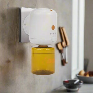 May include: A white and orange essential oil diffuser plugged into a wall outlet. The diffuser has a clear, yellow-tinted bottle filled with liquid. The device has a button and three indicator lights. The background shows a kitchen setting.