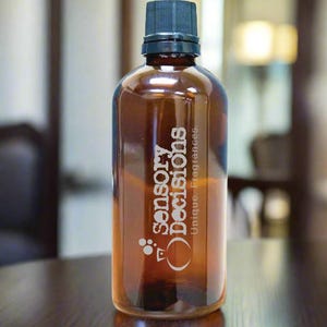 May include: A brown glass bottle with a black cap. The bottle is labelled "Sensory Decisions" and "Unique Fragrances".