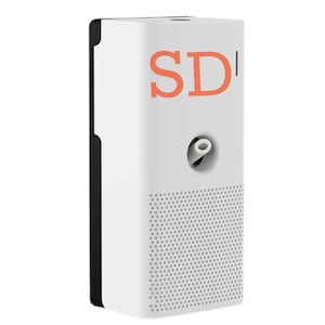 May include: White automatic air freshener with a black side panel and a small hole on the front. The front of the device has a grid pattern and the text "SDI" in orange.