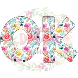 May include: Floral patterned letters "OK" in white with a light blue background. The letters are surrounded by a wreath of watercolor flowers.