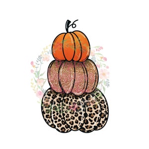 May include: A stack of three pumpkins, the top one is orange, the middle one is pink with glitter, and the bottom one is brown with a leopard print.