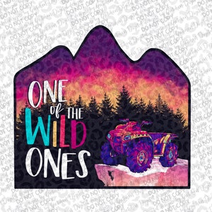 May include: A vibrant graphic with a mountain outline, sunset, and an ATV. The text reads "ONE of THE WILD ONES". The ATV is depicted in purple and pink, set against a backdrop of pine trees.