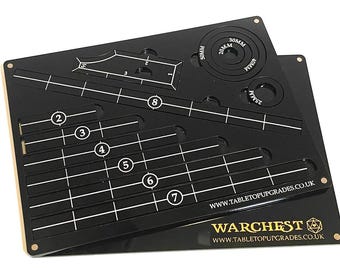 May include: Black acrylic template with white markings for creating miniature bases. The template includes circles with diameters of 20mm, 25mm, 30mm, and 40mm. The template also includes a grid with numbered rows and columns. The template is labeled "Warchrest" and "www.tabletopupgrades.co.uk".