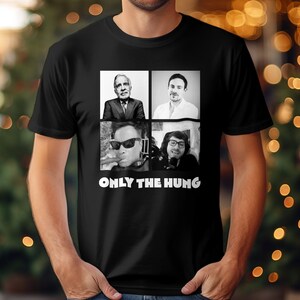 May include: Black t-shirt with a white graphic of four men's faces in squares. The text "ONLY THE HUNG" is below the images.