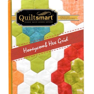 May include: A package for a quilting project featuring a honeycomb hex grid design. The package includes the "Quiltsmart" logo and text that reads "Honeycomb Hex Grid". The design features a variety of colors, including green, red, and white. The text "fast - easy - smart!" is also included.