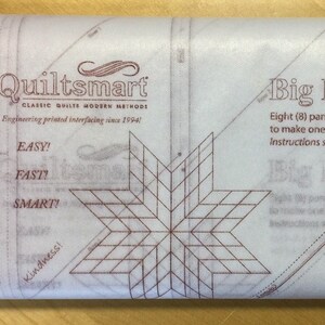 May include: A rolled package of quilting interfacing with the text "Quiltsmart" and "Big Bright Star". The package includes instructions and a star pattern. The text also includes "EASY! FAST! SMART!" and "Eight (8) panels are needed to make one Big Bright Star."