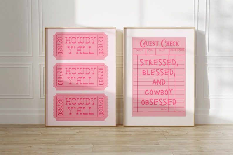 May include: Two framed prints with gold frames. One print features three pink tickets with "HOWDY Y'ALL" text. The other print is a pink guest check with the text "STRESSED, BLESSED AND COWBOY OBSESSED".