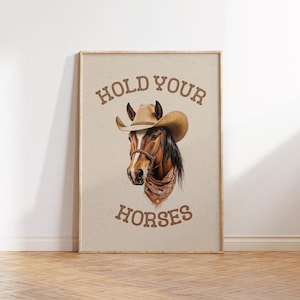 May include: A brown horse wearing a cowboy hat and bandana with the text "HOLD YOUR HORSES" on a beige background.