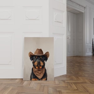 May include: A Rottweiler dog wearing a brown cowboy hat and a brown bandana. The dog is looking directly at the camera.