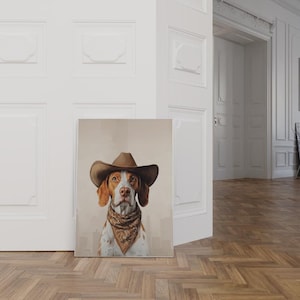 May include: A brown and white dog wearing a brown cowboy hat and a bandana. The dog is looking directly at the camera. The background is a light brown color.