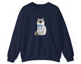 May include: A navy blue sweatshirt with a white cat wearing a blue bow tie printed on the front.