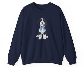 Può includere: Felpa blu navy con girocollo, raffigurante un'illustrazione ad acquerello di un cane bianco e nero con un fiocco blu. Il cane è centrato. Il top a maniche lunghe è realizzato in materiale morbido.