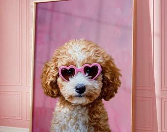 May include: A framed print of a small, light brown and white dog wearing pink heart-shaped sunglasses against a pink background.