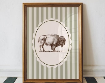 May include: A framed print featuring a detailed brown illustration of a bison. The artwork is set against a backdrop of vertical green and white stripes, framed in a wooden frame. The bison is inside a cream-colored oval with a decorative border.