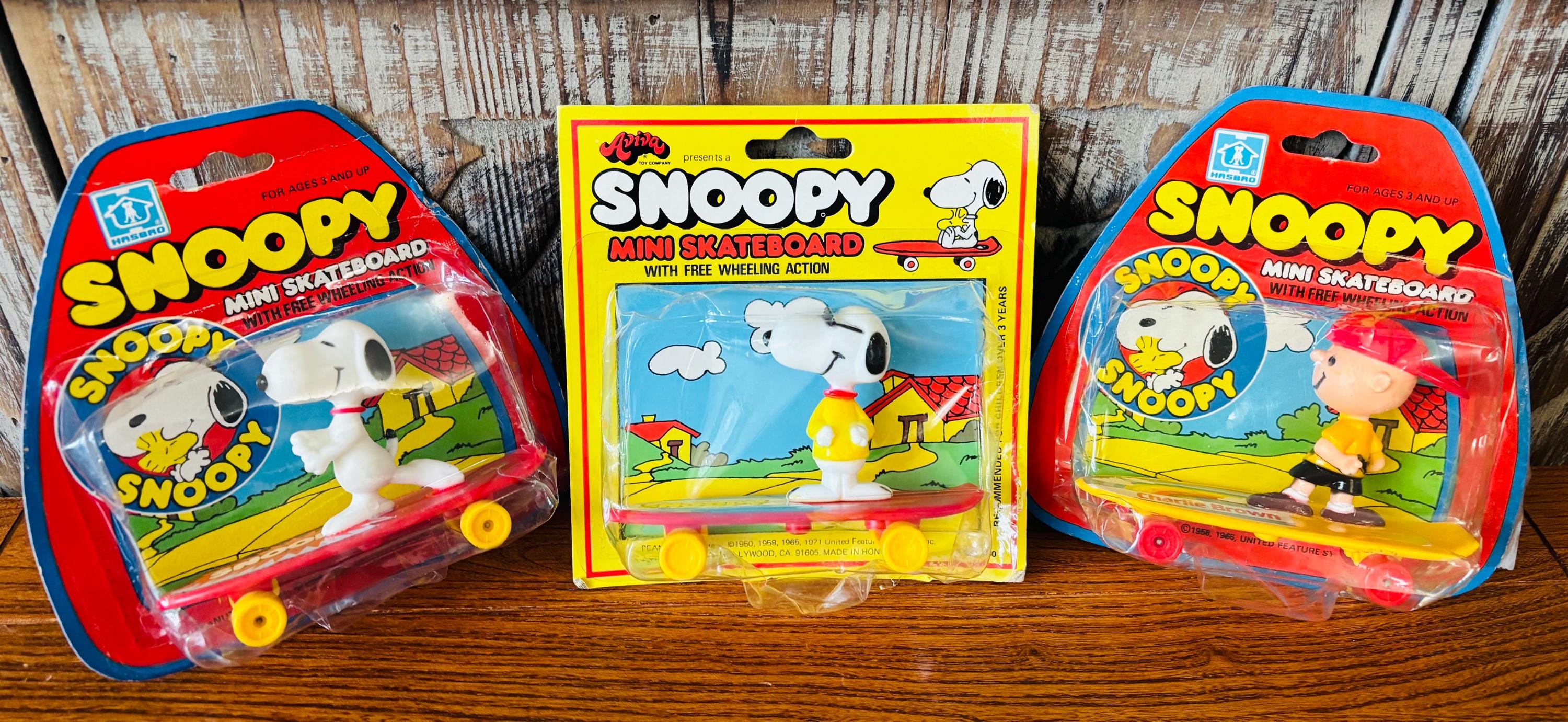 Vintage Snoopy Offering of Mini Skateboard Collectable Toys With
