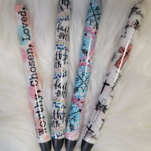 May include: Four pens with glitter and different designs. The pens have the following text: "Worthy, Chosen, Loved", "With Faith Over Fear", "Pray", and "Blessed".
