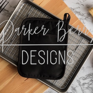 May include: Black oven mitt with the text "Parker Berry Designs" on a silver baking sheet with a wire rack. The baking sheet is on a wooden cutting board.