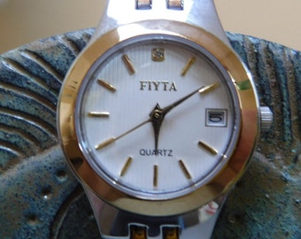 Fiyta watch Great Holiday gift! two tone. Marked in 5 places.  Works great new battery installed time & date work perfectly # 40516F