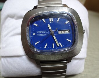 Rare Vintage Caravelle watch by Bulova Retro Style Blue Face, super cool shape, Day & Date! Works great nice band and watch Stainless Steel