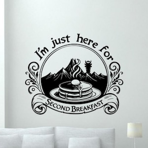 May include: Black and white graphic design of a mountain range with a stack of pancakes and the text "I'm just here for second breakfast".