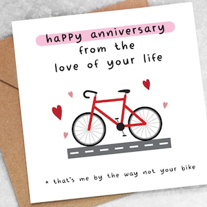 May include: A white card with a red bicycle illustration and the text "happy anniversary from the love of your life * that's me by the way not your bike".