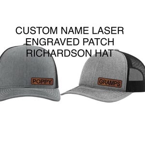 May include: Two gray and black trucker hats with custom laser engraved leather patches. The hats have the names "Poppy" and "Gramps" on the patches.
