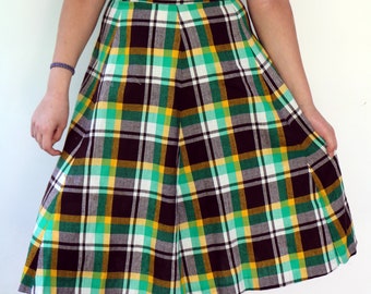 May include: A green, yellow, and black plaid skirt with a high waist and a flared silhouette.