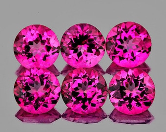 May include: Six round, faceted pink gemstones. The gemstones are arranged in two rows of three.