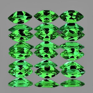 May include: A collection of 18 marquise-shaped green gemstones. The gemstones are arranged in three rows of six, with each row offset slightly from the one above it. The gemstones are all approximately the same size and shape, and they have a bright, vibrant green colour.