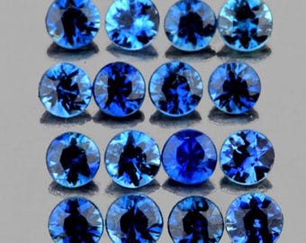May include: Sixteen round, faceted blue gemstones arranged in a four-by-four grid. Each stone features a brilliant cut with deep navy and bright azure light reflections, creating a sparkling, high-contrast appearance across the uniform circular shapes.