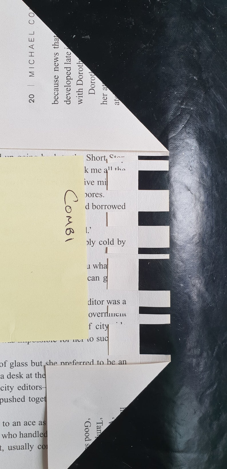 May include: A close-up of a page from a book with black and white text. The text reads "Short Story" and "k me all the pores." The text is partially obscured by a yellow sticky note with the word "COMBI" written on it.
