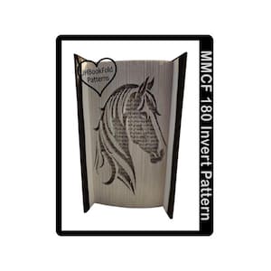 May include: A book fold pattern featuring a horse head design. The book is open, revealing the horse's silhouette created by folded pages. The text "JHBookFold Patterns" is in a heart-shaped logo. The text "MMCF 180 Invert Pattern" is on the right side.