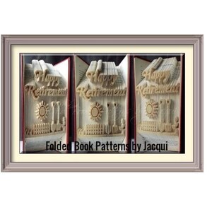 May include: A book art sculpture of a house with the words "Happy Retirement" folded into the pages. The house has a sun and garden tools. The book is framed in a light brown frame. The text "Folded Book Patterns by Jacqui" is at the bottom of the frame.
