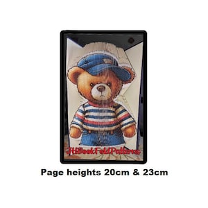 May include: A brown teddy bear wearing a blue and white striped shirt and a blue sailor hat. The bear is standing on a white background with the text "HitBookFoldPatterns" and "Page heights 20cm & 23cm".