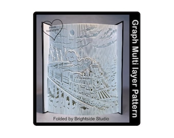 May include: A white papercraft model of a train traveling through a snowy forest. The model is folded into a book-like shape and features a moon and clouds in the background. The text "Graph Multi layer Pattern" is printed on the right side of the image. The text "Folded by Brightside Studio" is printed at the bottom of the image.