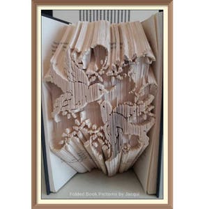 May include: A book with pages folded into a 3D design of three birds in a tree. The book is open and the design is visible from the side. The text "Folded Book Patterns by Jacqui" is visible at the bottom of the book.