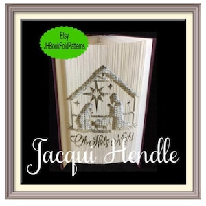 May include: A folded book art piece depicting the nativity scene with the text "Oh Holy Night" and the artist's name "Jacqui Hendle".