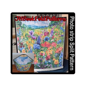 May include: A photo strip split pattern book fold with a colorful floral design. The book fold is made from strips of paper that are folded and glued together to create a three-dimensional effect. The design features a field of flowers in shades of red, yellow, blue, and green. The book fold is titled "Photo strip split pattern".